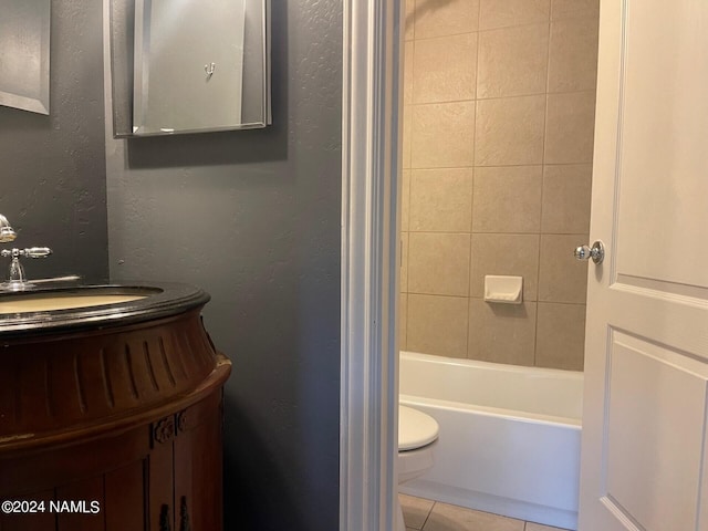 bathroom with tile patterned floors, toilet, and tiled shower / bath