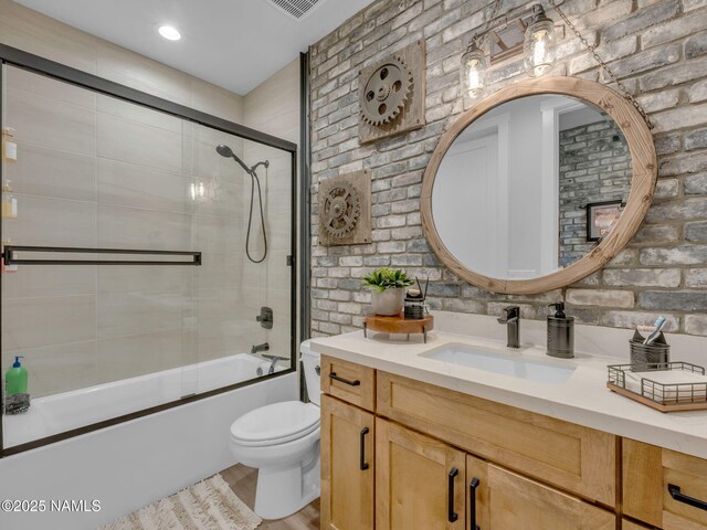 2566 S Cottonrose Ln, Flagstaff, AZ 86005 - full bath with vanity, toilet, shower / bath combination with glass door, and wood finished floors