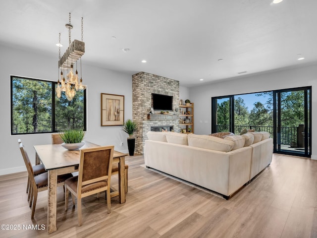 2566 S Cottonrose Ln, Flagstaff, AZ 86005 - living area featuring recessed lighting, a fireplace, light wood-style floors, and baseboards