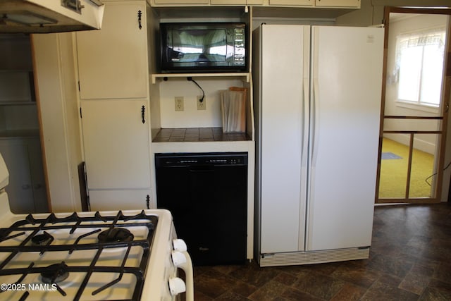 620 W Elm St, Winslow, AZ 86047 - kitchen with black appliances, stone finish floors, under cabinet range hood, tile counters, and white cabinets