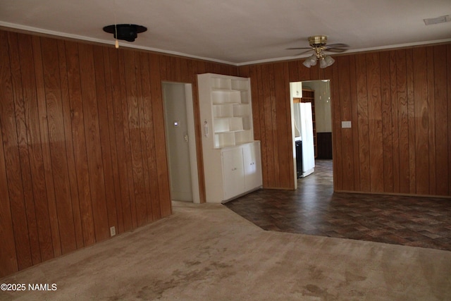 620 W Elm St, Winslow, AZ 86047 - unfurnished room featuring a ceiling fan, wood walls, and carpet