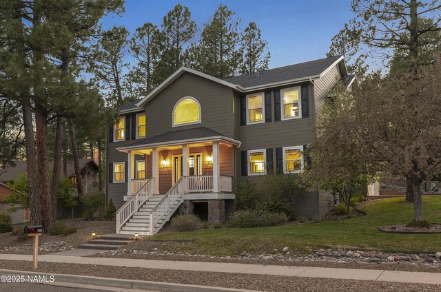 1085 N Conifer Rd, Flagstaff, AZ 86001 - view of front of home with a porch, stairs, and a front yard