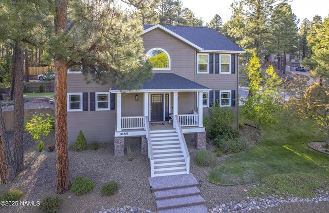 1085 N Conifer Rd, Flagstaff, AZ 86001 - view of front of home with roof with shingles, stairway, and covered porch