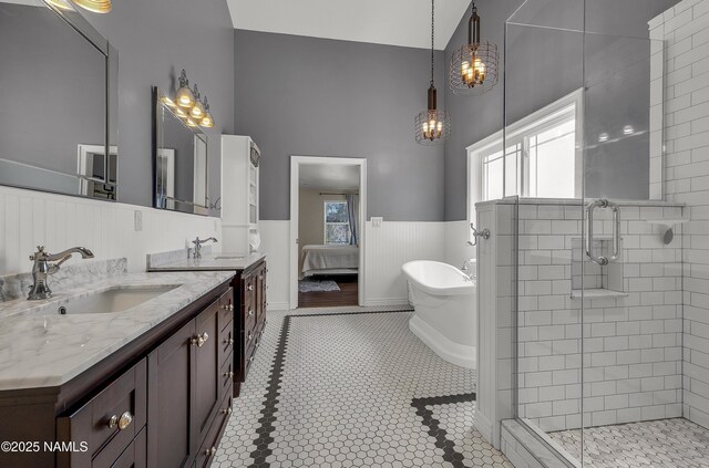 1085 N Conifer Rd, Flagstaff, AZ 86001 - full bath with vanity, wainscoting, a shower stall, a soaking tub, and ensuite bath