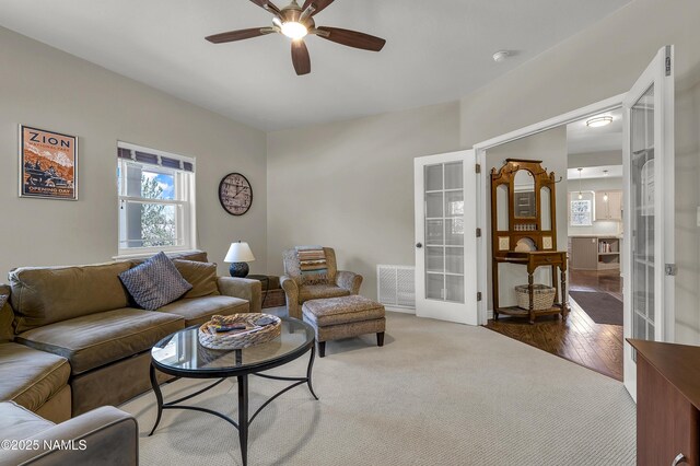 1085 N Conifer Rd, Flagstaff, AZ 86001 - carpeted living room with french doors, ceiling fan, and wood finished floors