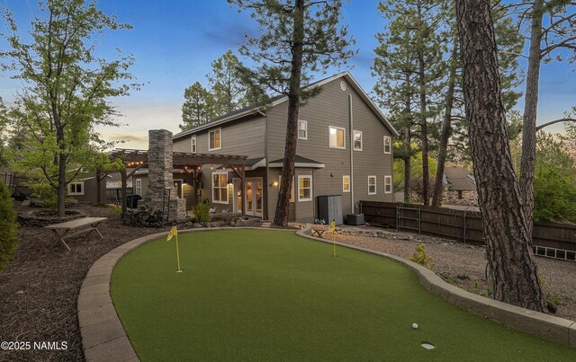 1085 N Conifer Rd, Flagstaff, AZ 86001 - back of property featuring a pergola, a putting area, and central air condition unit