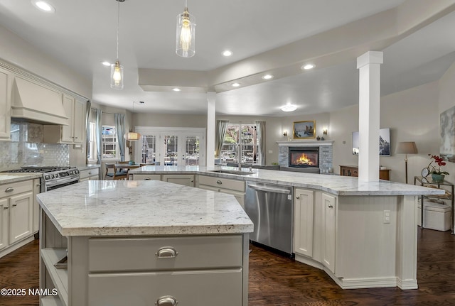 1085 N Conifer Rd, Flagstaff, AZ 86001 - kitchen with stainless steel dishwasher, custom exhaust hood, a kitchen island, open floor plan, and recessed lighting