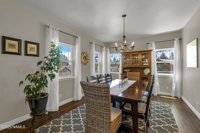 1085 N Conifer Rd, Flagstaff, AZ 86001 - dining room featuring a chandelier, dark wood-style flooring, and baseboards