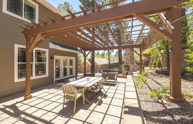 1085 N Conifer Rd, Flagstaff, AZ 86001 - view of patio featuring french doors, an outdoor stone fireplace, a pergola, and outdoor dining area
