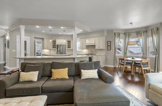 1085 N Conifer Rd, Flagstaff, AZ 86001 - living room with ornate columns, baseboards, dark wood finished floors, plenty of natural light, and recessed lighting