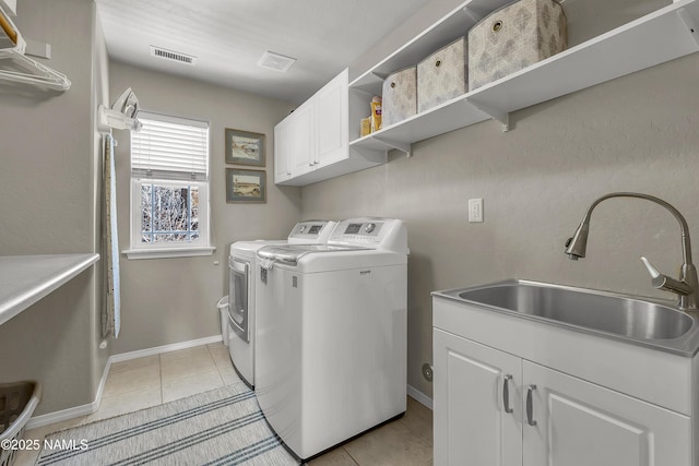 1085 N Conifer Rd, Flagstaff, AZ 86001 - laundry area with cabinet space, independent washer and dryer, light tile patterned flooring, and baseboards