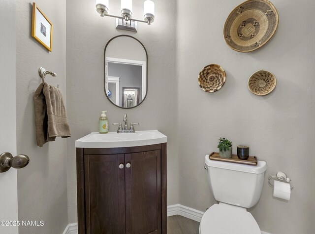 1085 N Conifer Rd, Flagstaff, AZ 86001 - half bath featuring vanity, toilet, and baseboards
