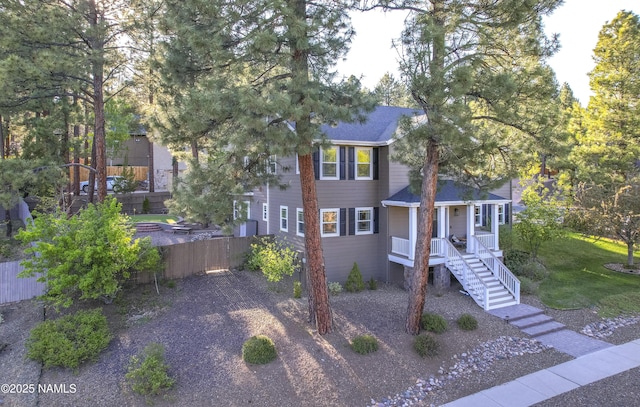 1085 N Conifer Rd, Flagstaff, AZ 86001 - view of front facade with a shingled roof and covered porch