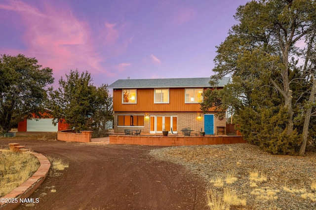 view of front of home with a garage and an outdoor structure