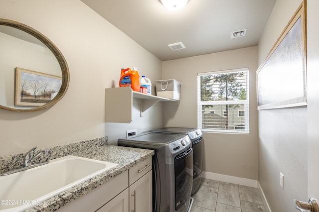 2845 W Hare Dr, Flagstaff, AZ 86001 - laundry area with visible vents, a sink, baseboards, separate washer and dryer, and cabinet space
