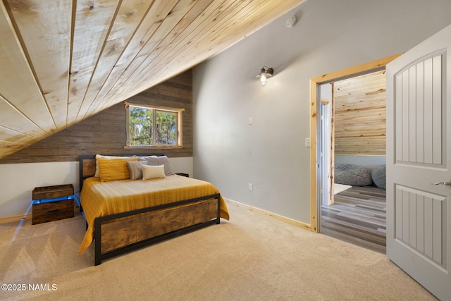 carpeted bedroom with wooden walls, vaulted ceiling, and wooden ceiling
