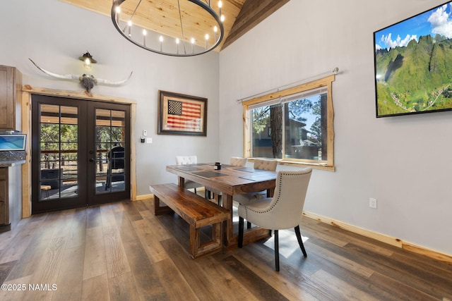 dining area with baseboards, wood finished floors, and french doors