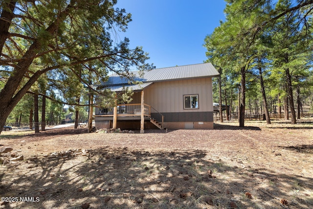 view of property exterior with stairway, a deck, metal roof, and crawl space