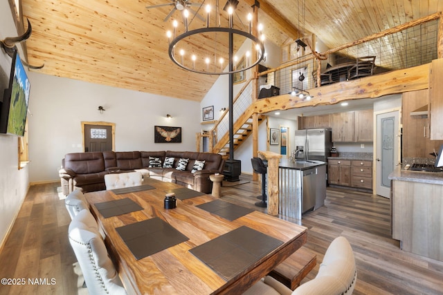 dining room with dark wood-style flooring, stairway, high vaulted ceiling, baseboards, and wooden ceiling