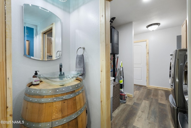 interior space with baseboards, wood finished floors, and vanity