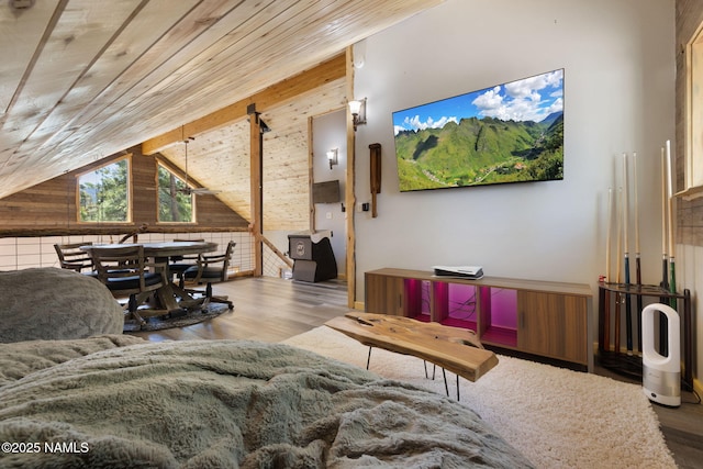 living room with wood walls, wood finished floors, and lofted ceiling
