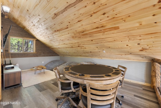 dining space with wood ceiling, baseboards, wood finished floors, and lofted ceiling