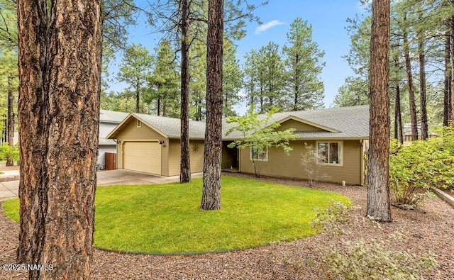 ranch-style home featuring a garage, driveway, and a front yard