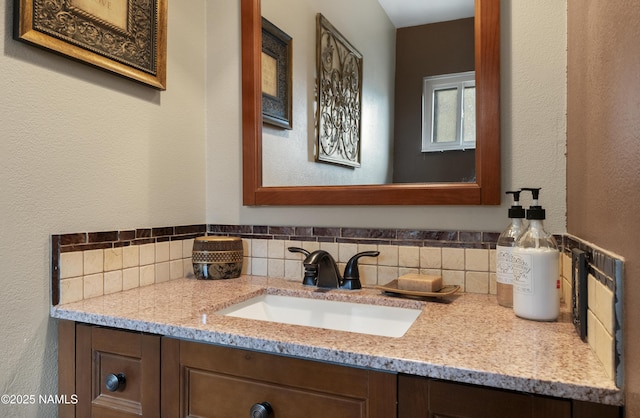 bathroom with decorative backsplash and vanity