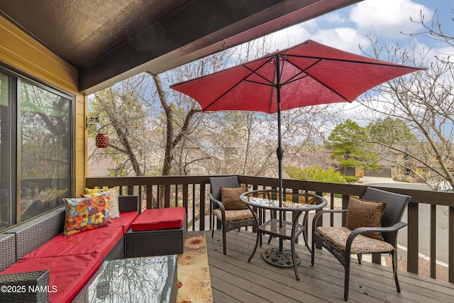 wooden terrace with an outdoor hangout area