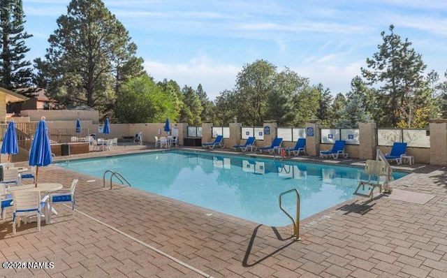 view of swimming pool with a patio area