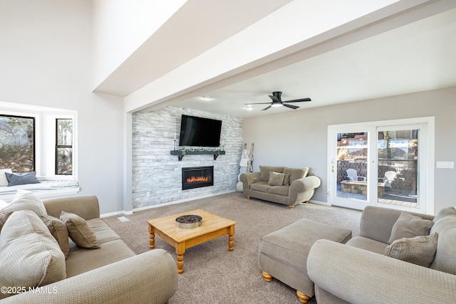 5495 E Crisp Hill Rd, Flagstaff, AZ 86004 - carpeted living area with a fireplace, a ceiling fan, and baseboards