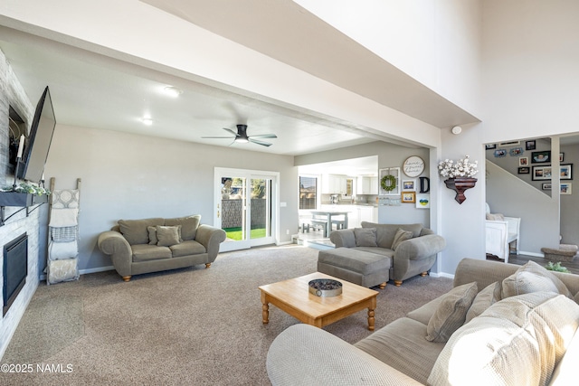 5495 E Crisp Hill Rd, Flagstaff, AZ 86004 - living room with a glass covered fireplace, carpet, baseboards, and a ceiling fan