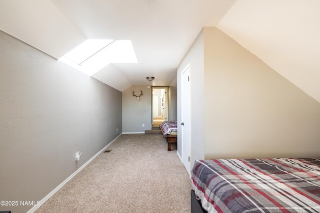 5495 E Crisp Hill Rd, Flagstaff, AZ 86004 - unfurnished bedroom with vaulted ceiling with skylight, carpet flooring, visible vents, and baseboards