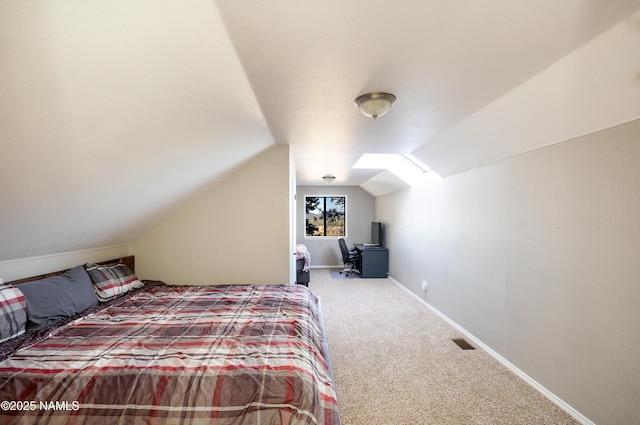 5495 E Crisp Hill Rd, Flagstaff, AZ 86004 - carpeted bedroom featuring visible vents, vaulted ceiling with skylight, and baseboards