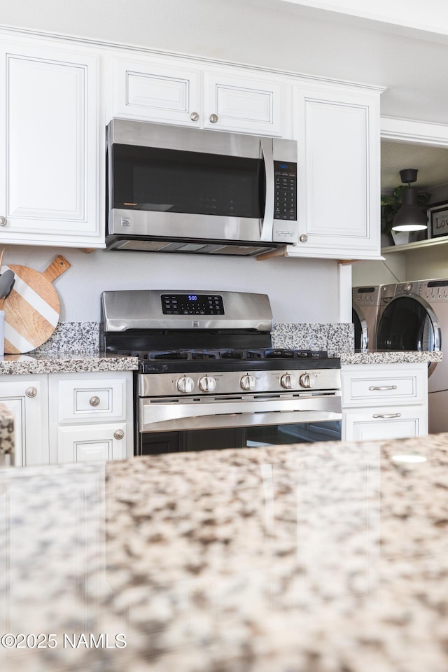 5495 E Crisp Hill Rd, Flagstaff, AZ 86004 - kitchen featuring white cabinets, light stone counters, and appliances with stainless steel finishes