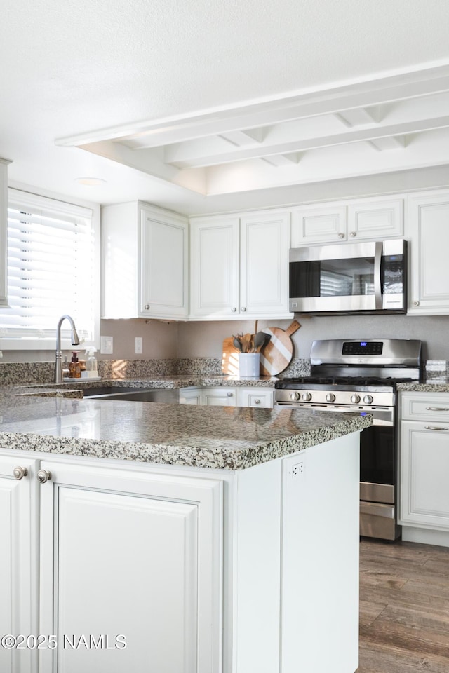 5495 E Crisp Hill Rd, Flagstaff, AZ 86004 - kitchen featuring white cabinetry, light stone counters, wood finished floors, and appliances with stainless steel finishes