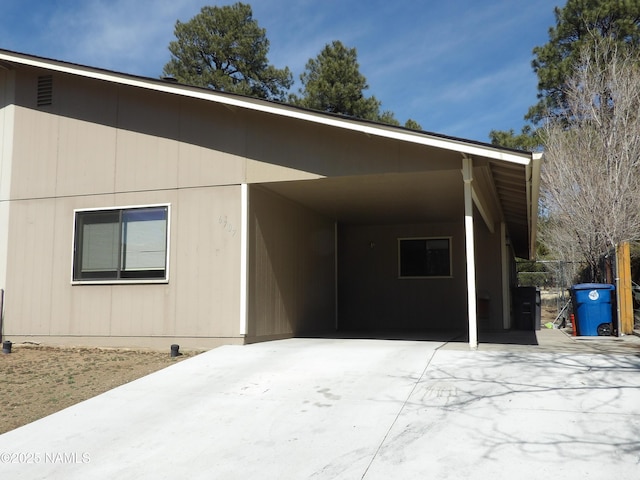 exterior space with a carport and concrete driveway