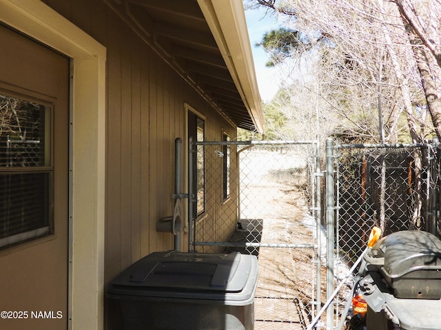 view of side of home with fence and a gate