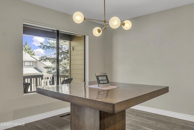 2800 N Saddleback Way Unit 2, Flagstaff, AZ 86004 - unfurnished dining area with baseboards, a notable chandelier, and dark wood-type flooring