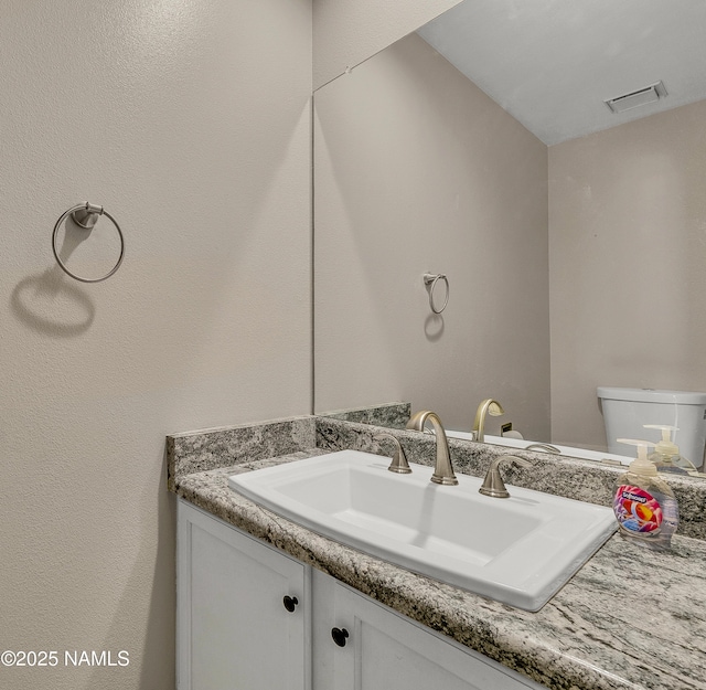 2800 N Saddleback Way Unit 2, Flagstaff, AZ 86004 - half bathroom with visible vents, vanity, and toilet