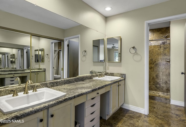 2800 N Saddleback Way Unit 2, Flagstaff, AZ 86004 - full bathroom featuring a tile shower, baseboards, toilet, and a sink