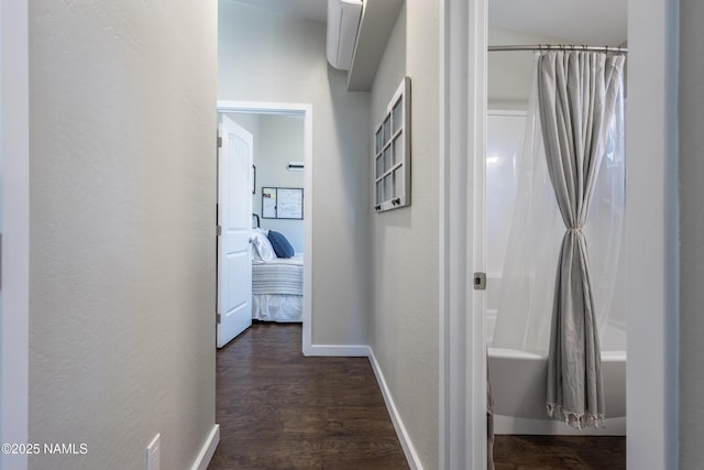 hallway with dark hardwood / wood-style flooring