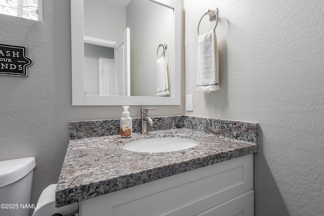 bathroom with vanity and toilet