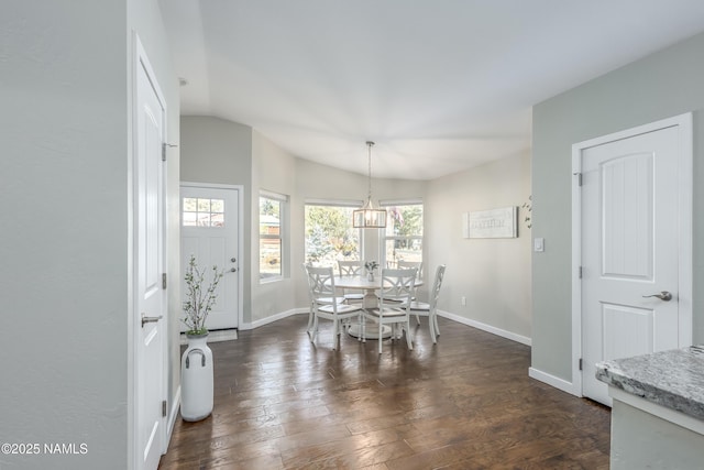 dining room with vaulted ceiling and dark hardwood / wood-style flooring