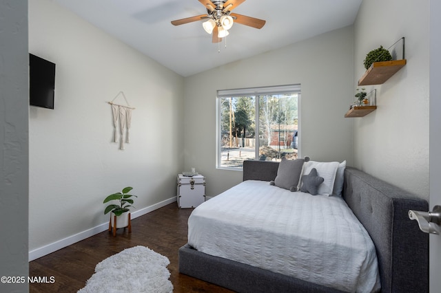 bedroom featuring ceiling fan, dark hardwood / wood-style floors, and lofted ceiling