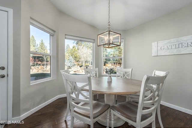 dining space featuring an inviting chandelier and dark hardwood / wood-style flooring