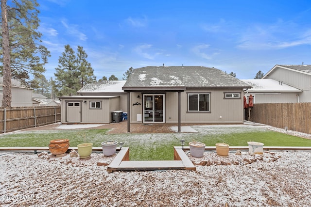 rear view of house with an outbuilding, a yard, and a fenced backyard