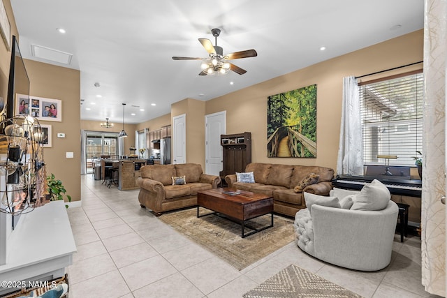 living room featuring light tile patterned floors, ceiling fan, baseboards, and recessed lighting