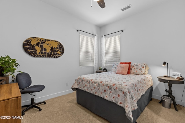 bedroom with baseboards, a ceiling fan, visible vents, and light colored carpet