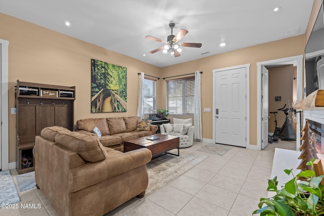 living room featuring light tile patterned floors, baseboards, a ceiling fan, and recessed lighting